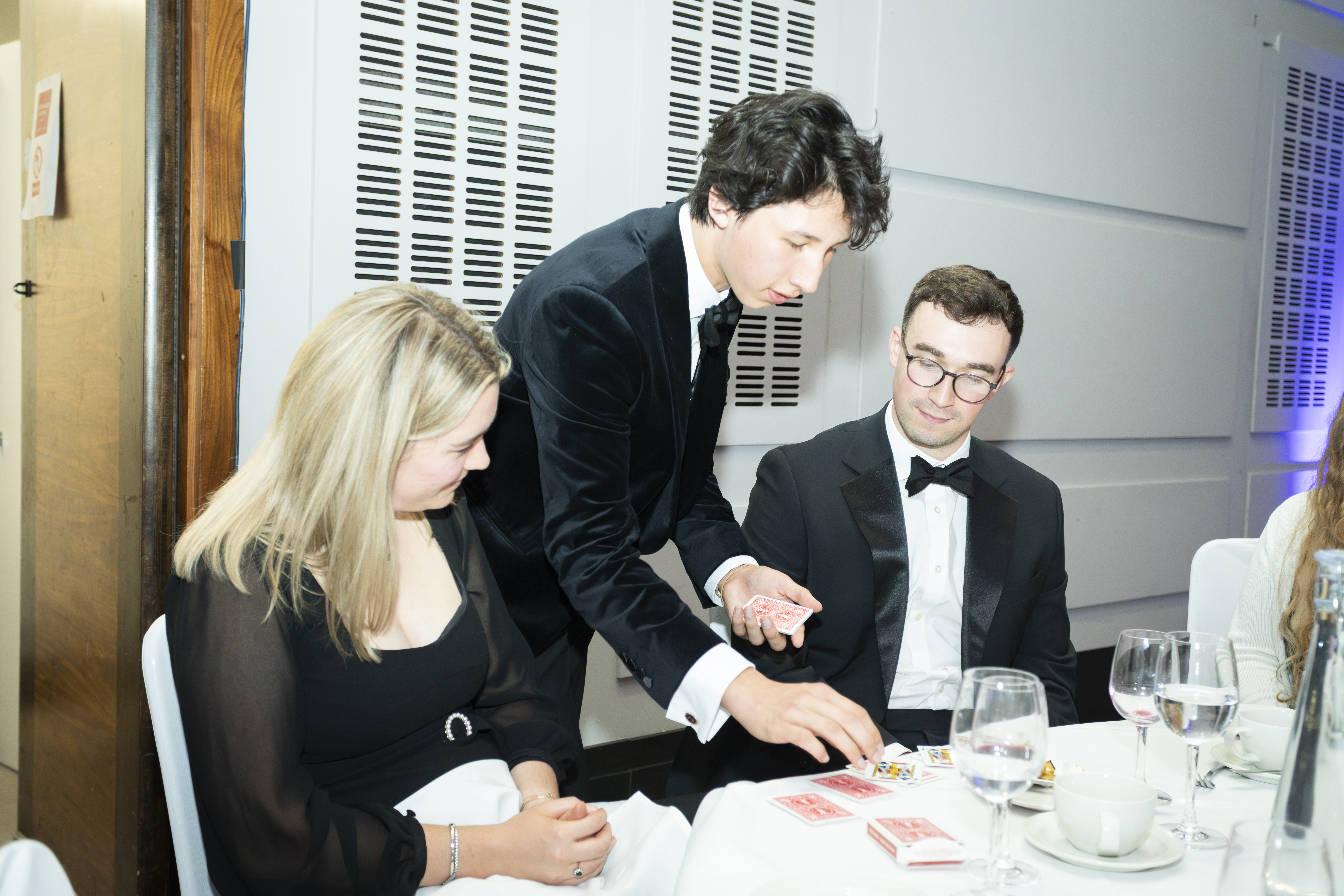 Noah performing magic among event guests